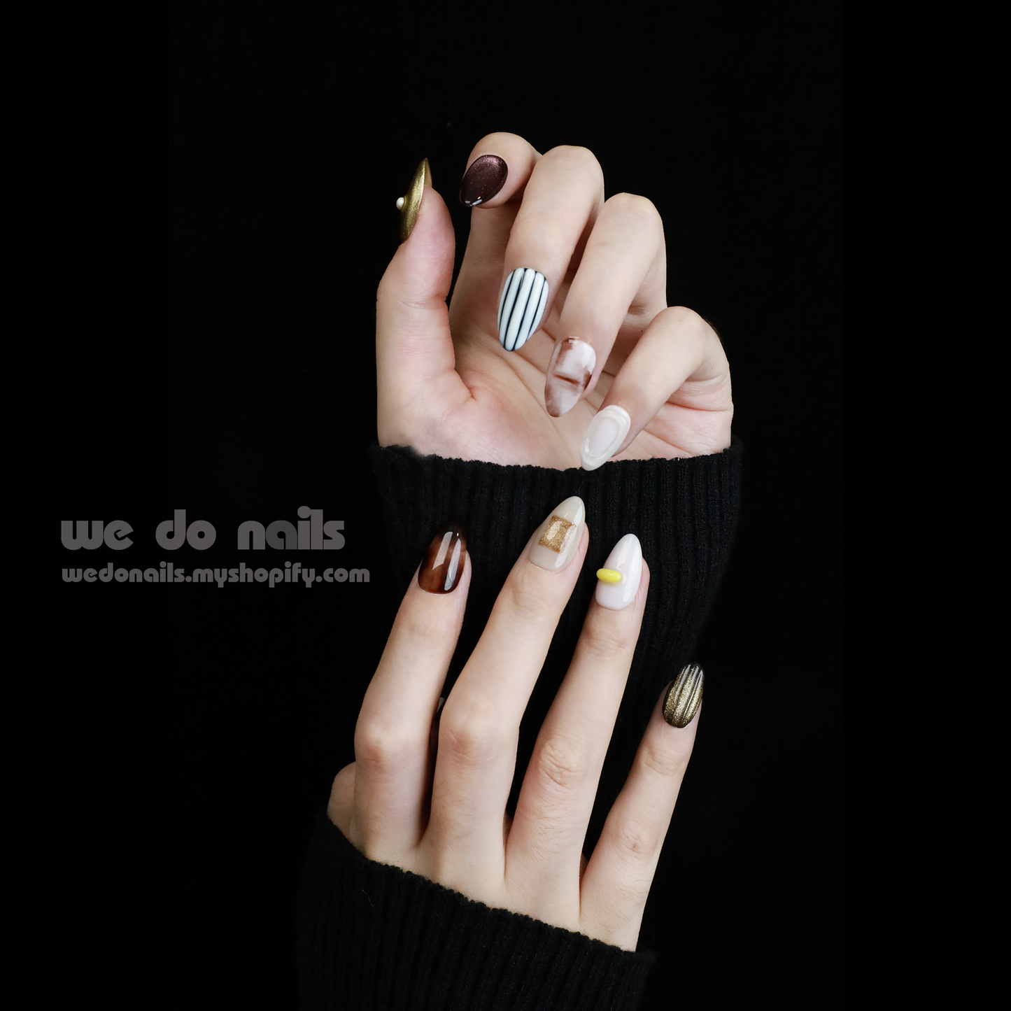 A hand with Elegant Press-On Nails holding a large white mug displays glittery stripes, marbling, and metallic textures with hints of gold. The black background has text: We Do Nails followed by the URL wedonails.myshopify.com.