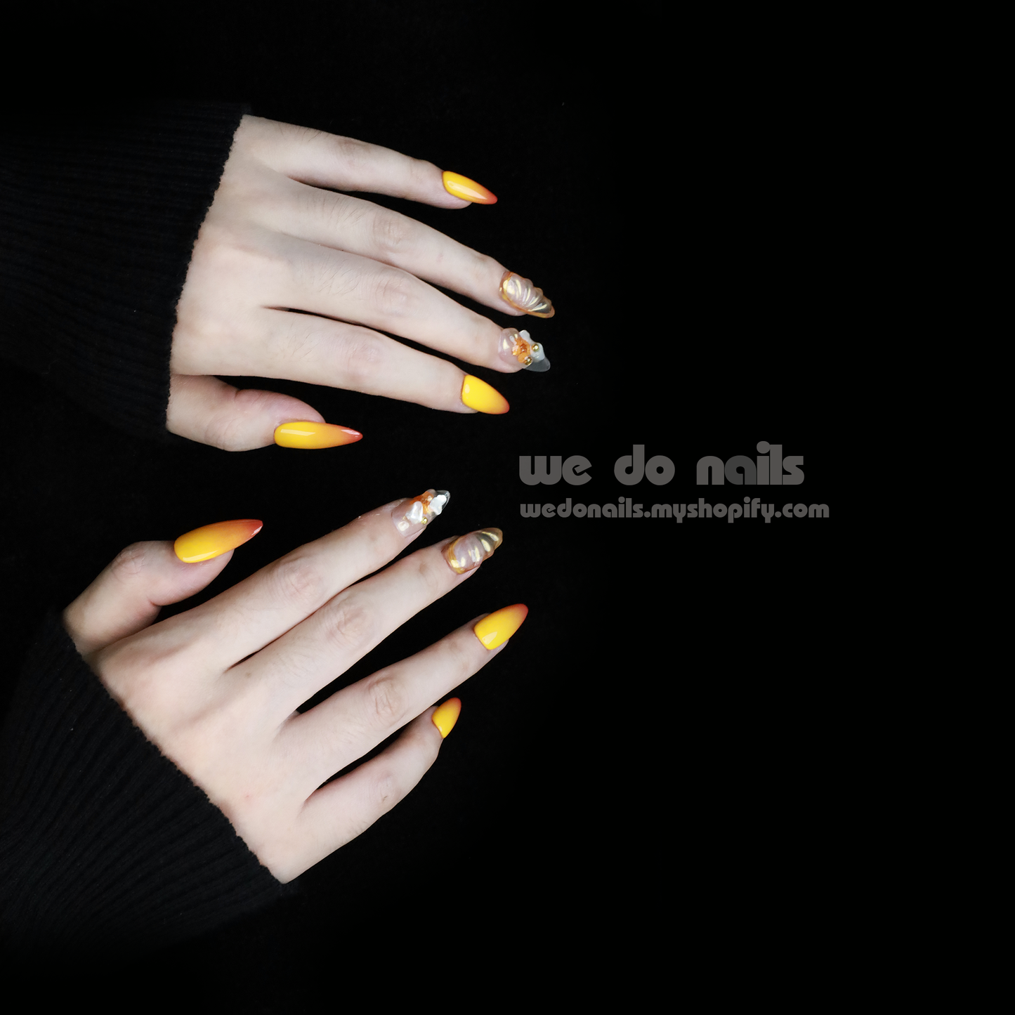 A close-up shows hands flaunting We Do Nails Sunset Glow Press-On Nails featuring long, almond-shaped manicure with bright orange, yellow, and white floral and marble patterns for a salon-quality finish. A SHIP NEXT DAY label is in the top left corner.
