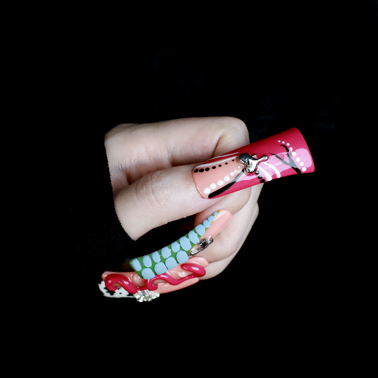 Two hands showcase the Avant-Garde 3D Extra Long Duck Nails by We Do Nails, featuring blue textures, cow print, pink patterns, and colorful designs against a black background. Ship Next Day text highlights custom size and nail measurement personalization options.