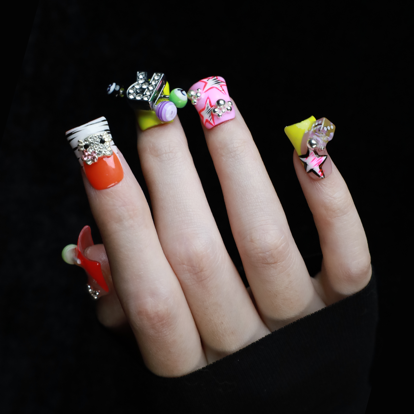 A hand with intricately decorated Neon Pop Star Short Duck Press-On Nails by We Do Nails clutches a large white mug. The duck-shaped neon nails showcase various designs, gems, and tiny figures. A pink banner in the top left corner reads SHIP NEXT DAY.