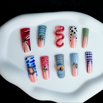 Two hands showcase the Avant-Garde 3D Extra Long Duck Nails by We Do Nails, featuring blue textures, cow print, pink patterns, and colorful designs against a black background. Ship Next Day text highlights custom size and nail measurement personalization options.
