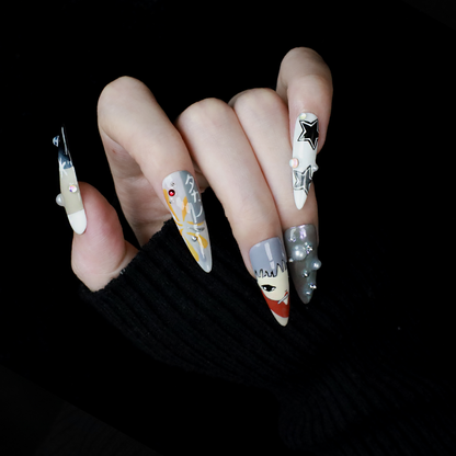 A hand with long, pointed Japanese-Inspired Artistic Press-On Nails by We Do Nails showcases camo patterns in green, red, and gray. Combining kawaii aesthetic and artistic motifs that suggest anime nail art, the hand is partially covered by a black sleeve.