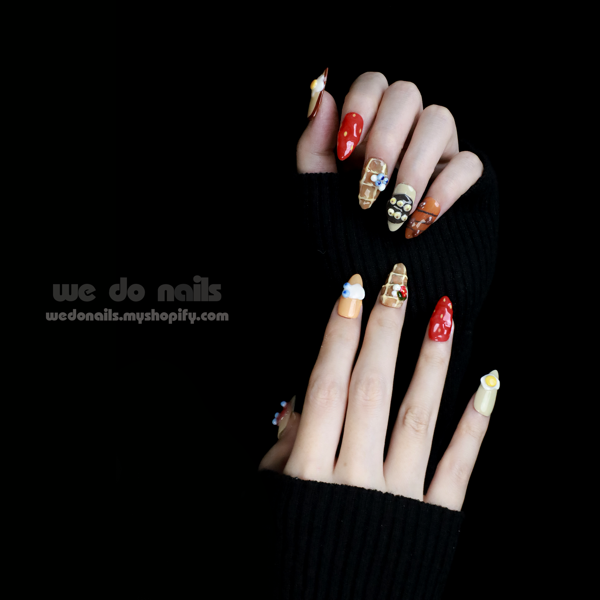 A hand with whimsical nail art holds a small white ceramic handbag against a black backdrop. SHIP NEXT DAY is displayed in pink at the top. The We Do Nails Gourmet Delight Press-On Nails promise vibrant patterns to dazzle for any occasion.