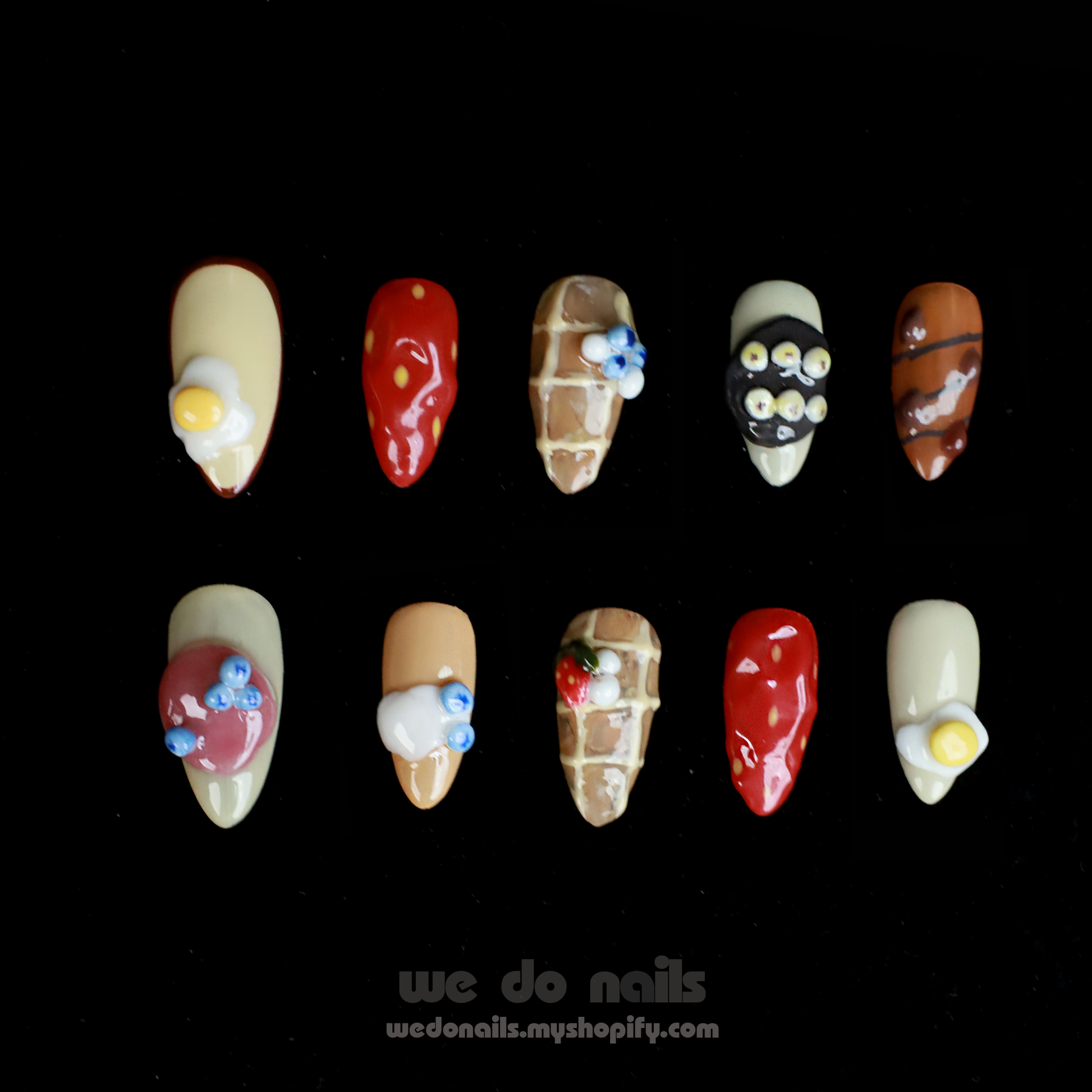 A hand with whimsical nail art holds a small white ceramic handbag against a black backdrop. SHIP NEXT DAY is displayed in pink at the top. The We Do Nails Gourmet Delight Press-On Nails promise vibrant patterns to dazzle for any occasion.