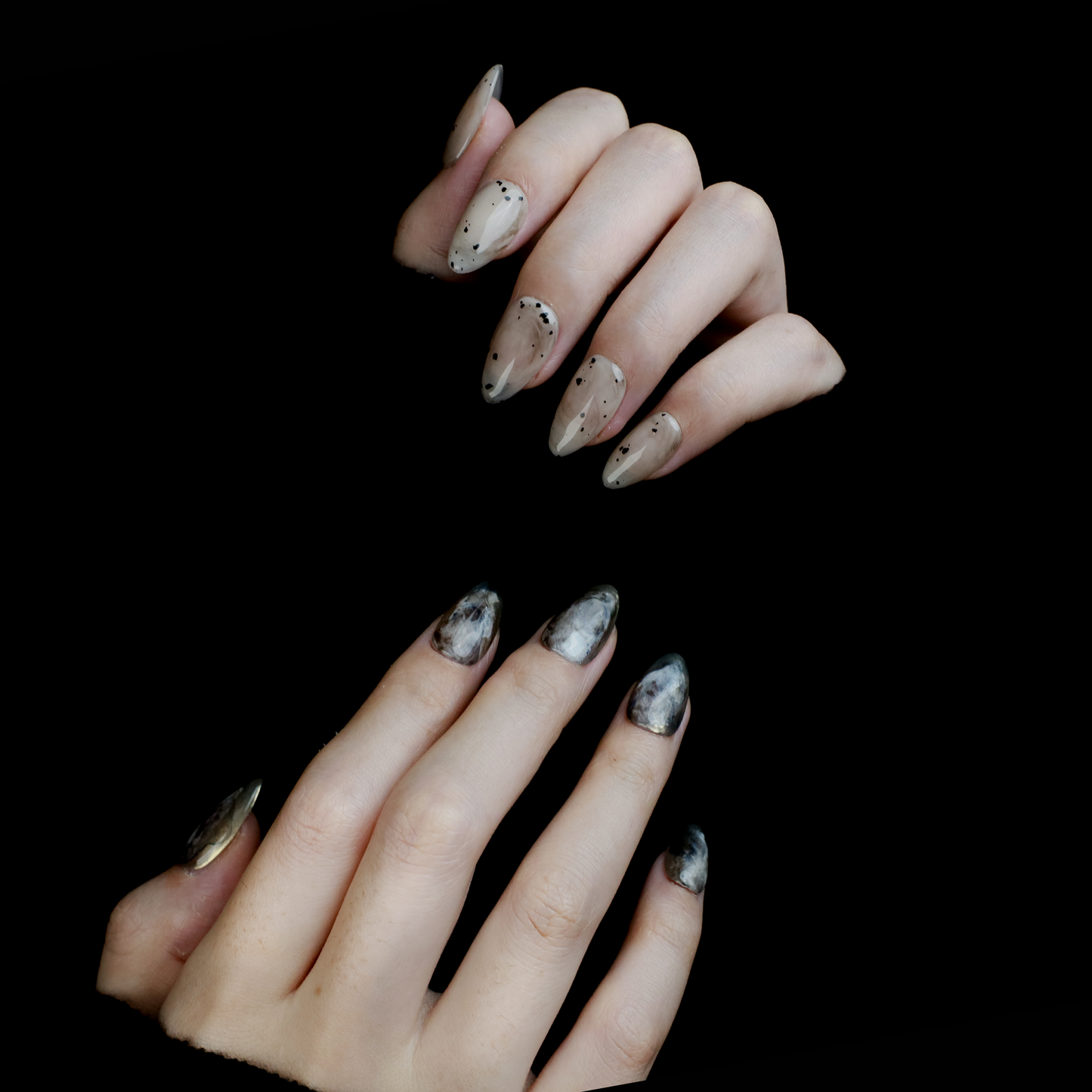 Hands showcasing We Do Nails Marble and Speckled Press On Nails, almond-shaped with a high-gloss shine and scattered speckles, perfectly highlighted against a solid black background.